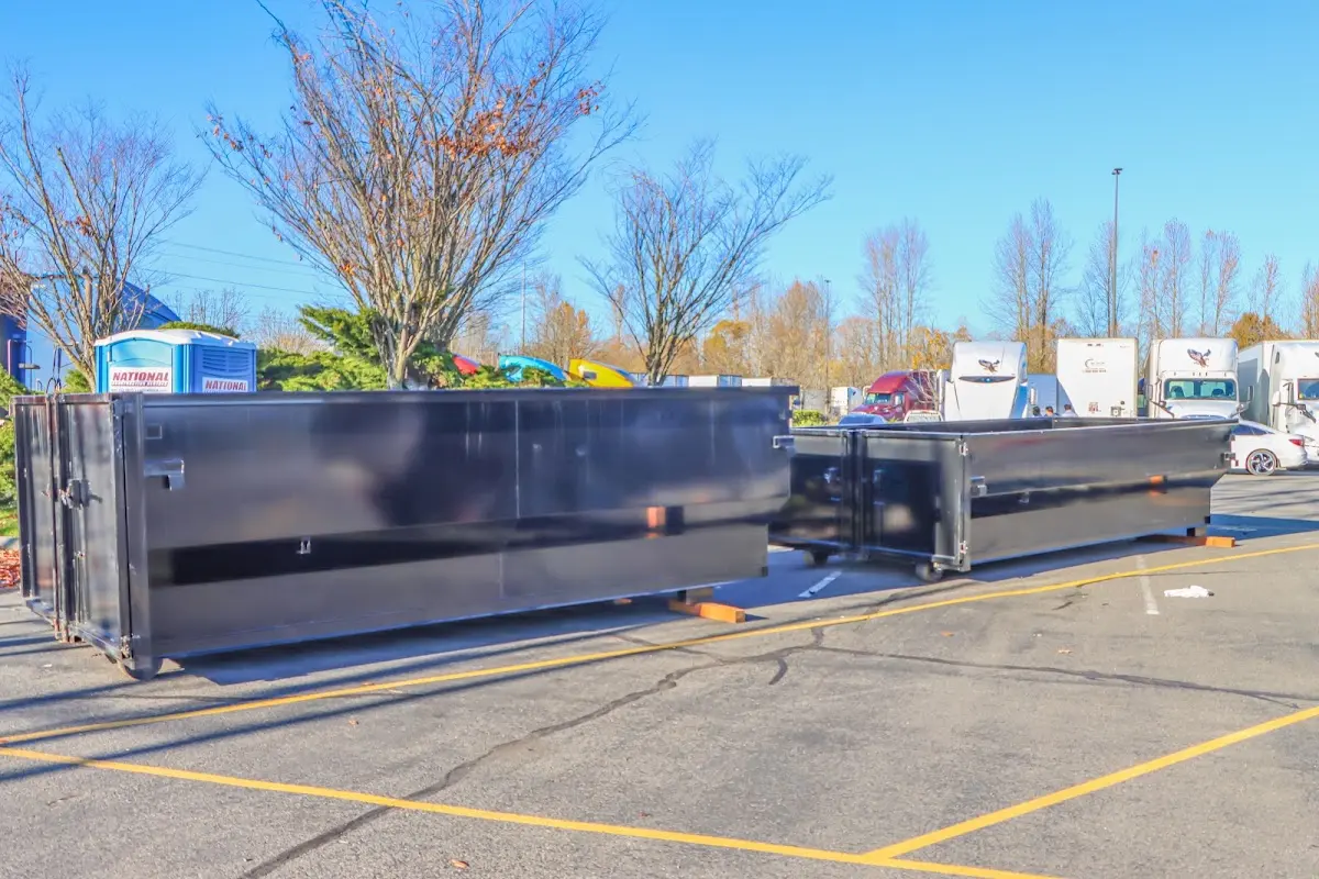 Professional dumpster rental service with roll-off container on residential driveway in Laurens